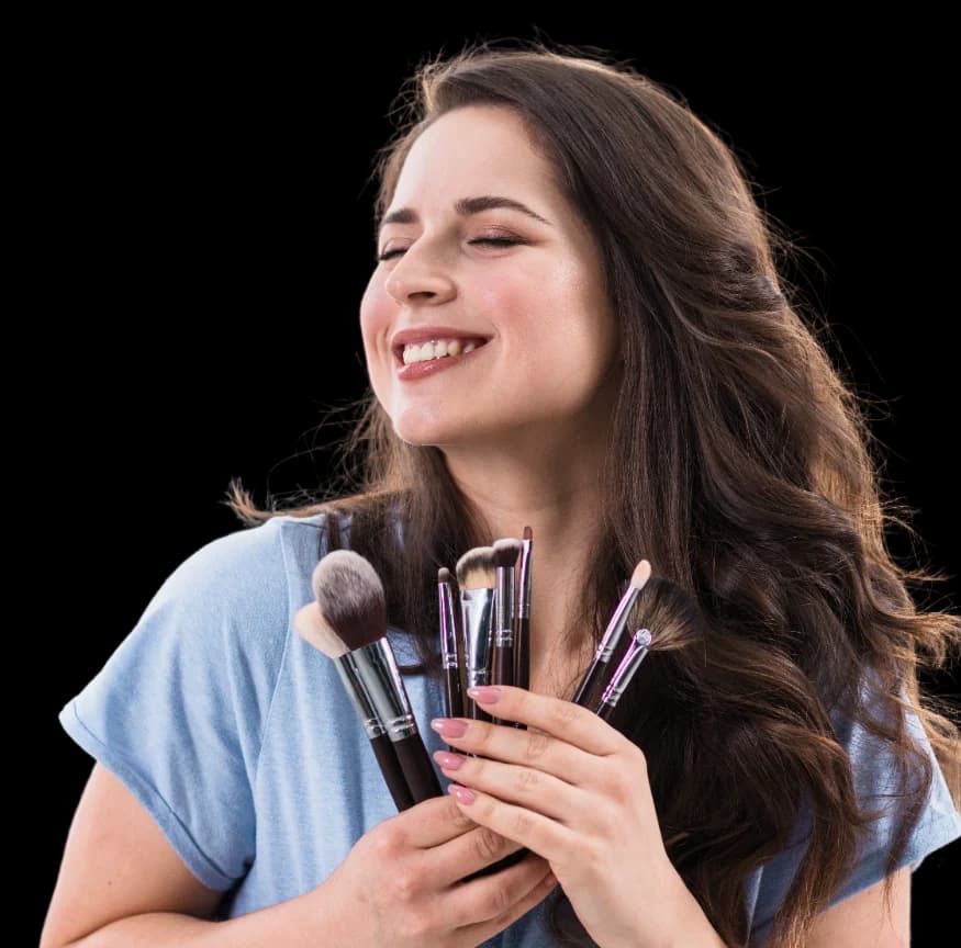 Stylist holding a set of makeup brushes